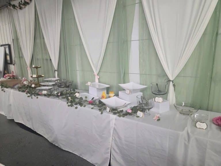 A head table with a draped backdrop