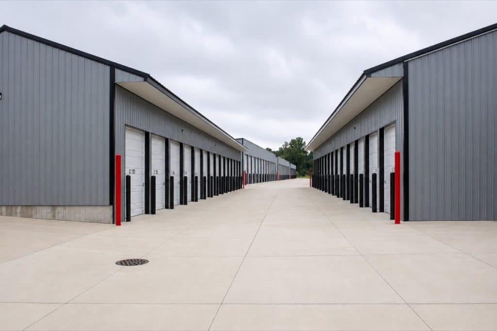 Paved driveway between two rows of storage units